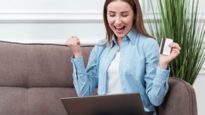 Woman sitting on couch shopping online