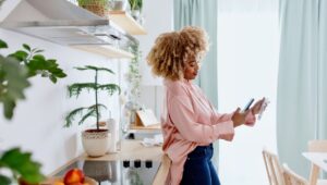 Woman scanning a receipt on her phone in kitchen