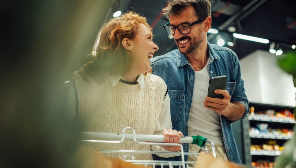 Couple shopping in store with phone