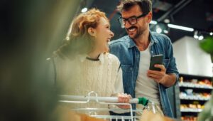 Couple shopping in store with phone