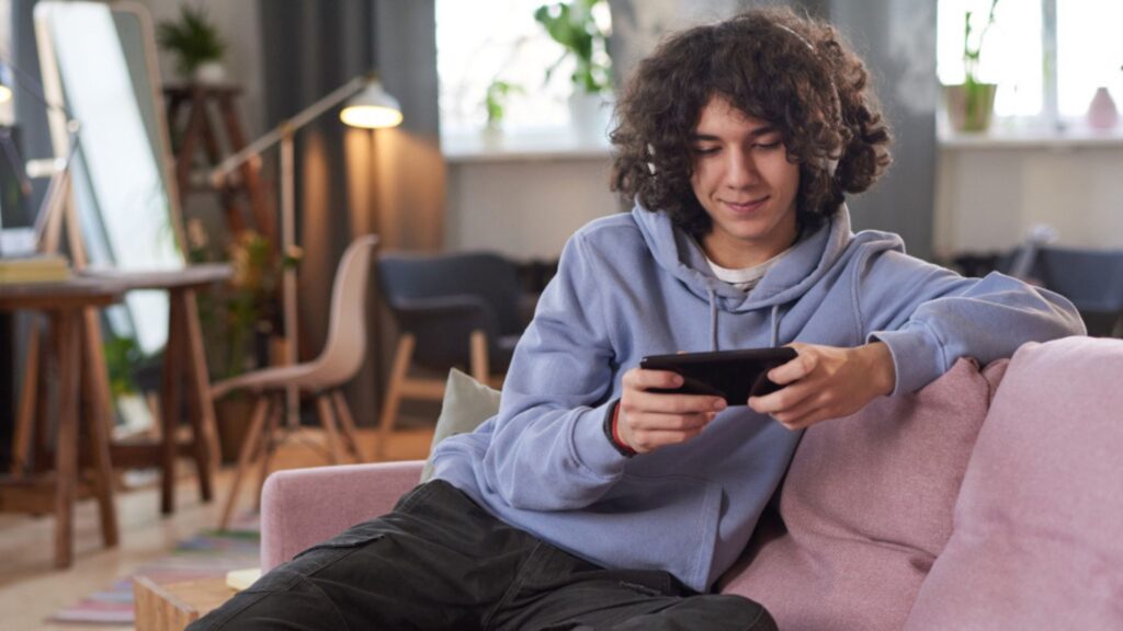 Person playing video games on the couch