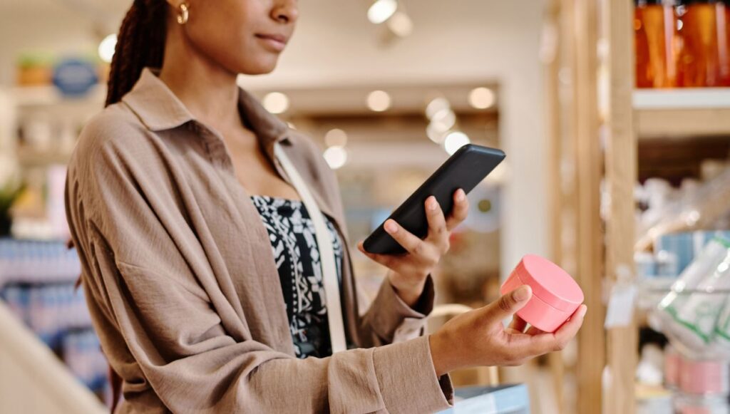 Woman taking photo of item while shopping in store