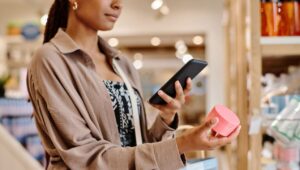 Woman taking photo of item while shopping in store