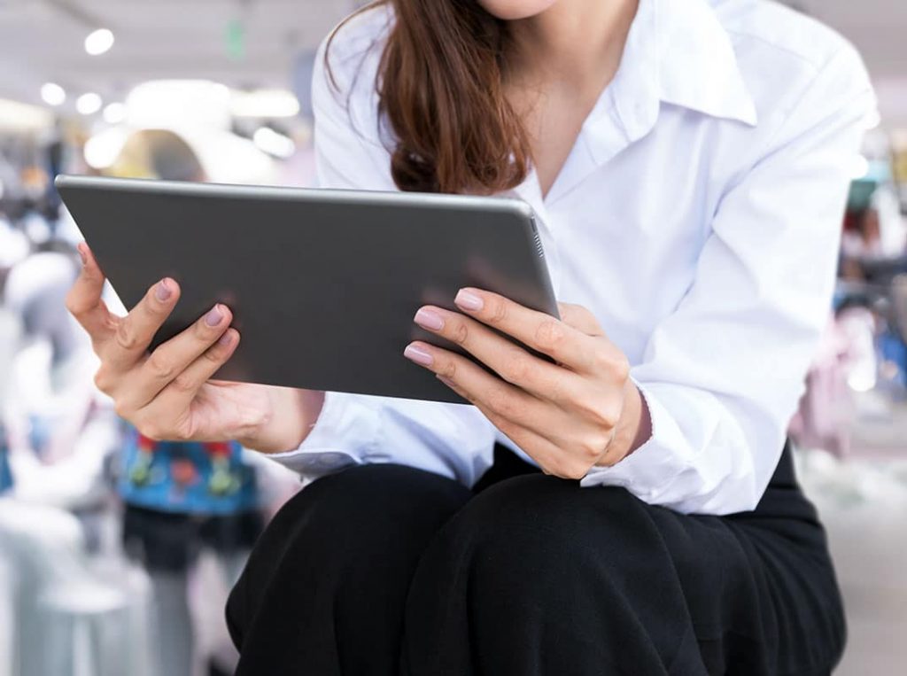 Woman using a tablet while shopping