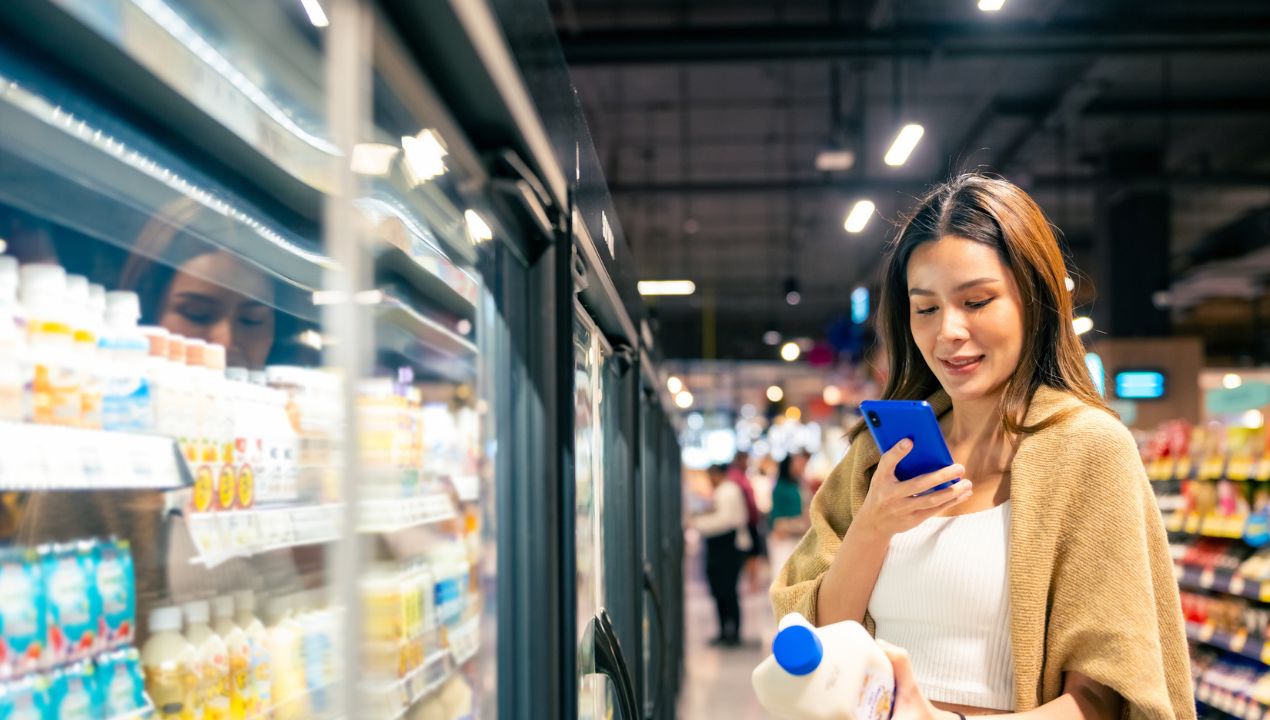 woman looking at milk to scan
