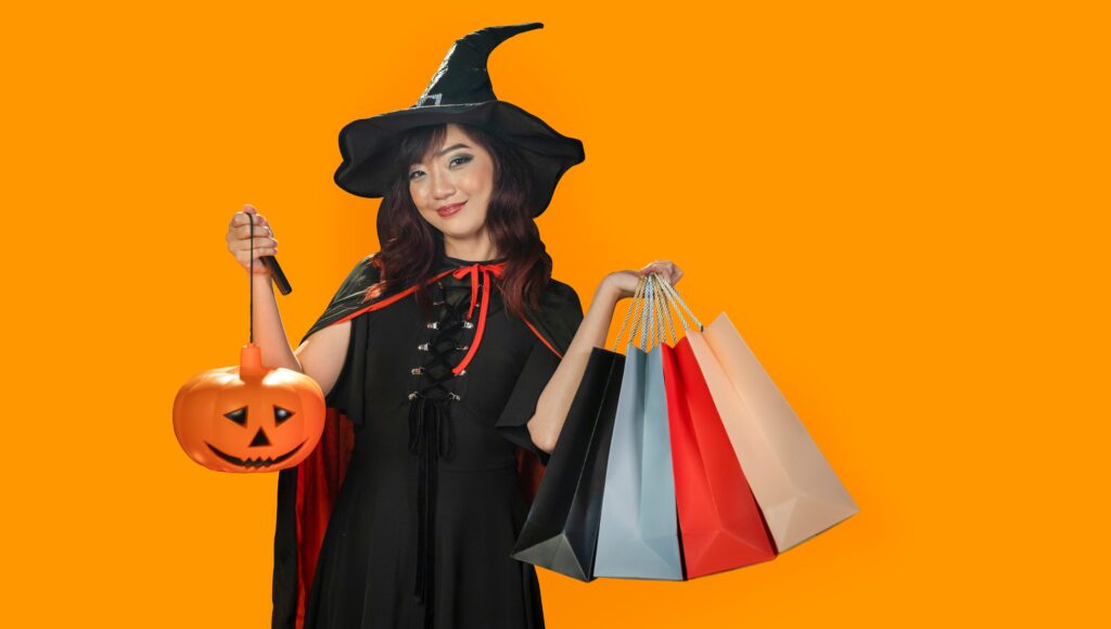 Woman in witch costume and shopping bags