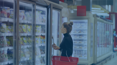 Consumer searching the frozen aisle