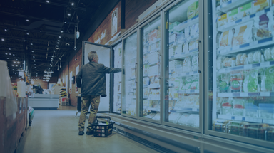Man looking at Freezer aisle